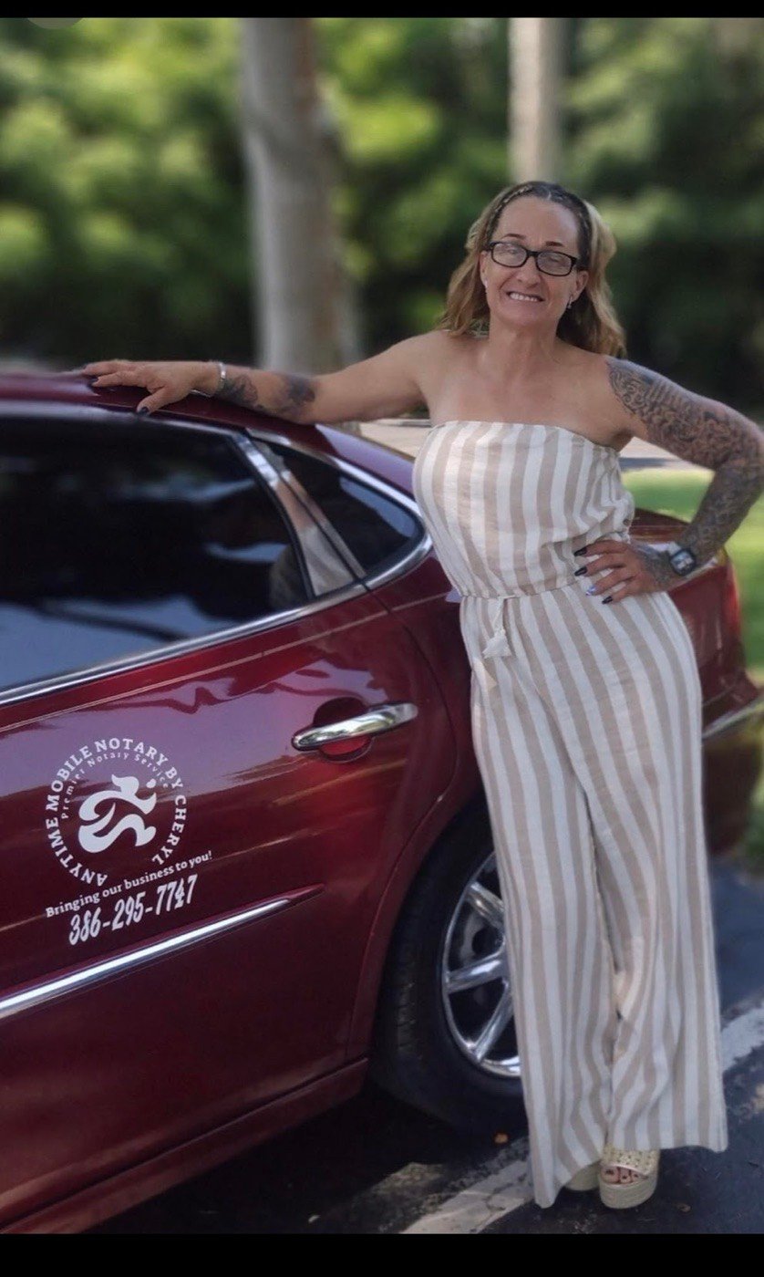 Cheryl Lucas beside her car, which carries the Anytime Mobile Notary branding