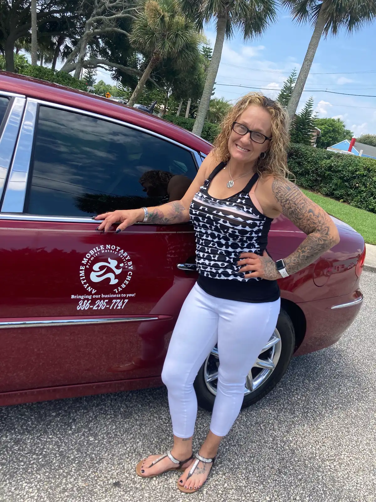 Cheryl Lucas standing beside her car, which carries the Anytime Mobile Notary logo and phone number on the door